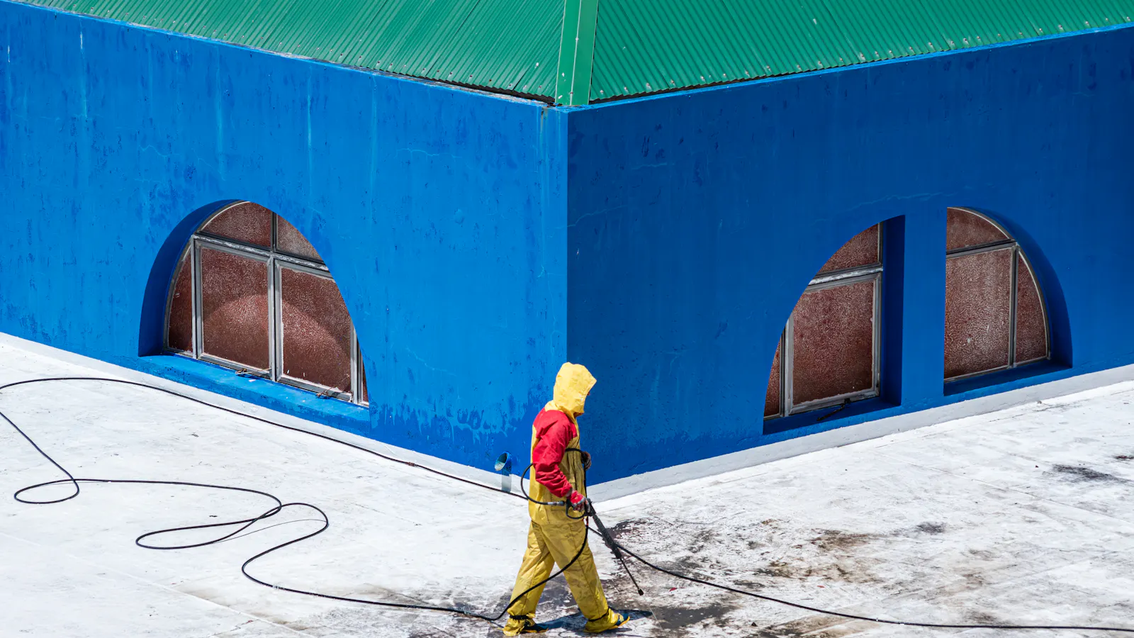 Technician pressure-washing a clean Oakville driveway